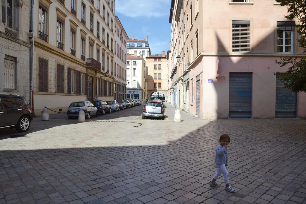A cobblestoned street in the Ainay quarter of Lyon, France — the kind of uneven stone surface that demands grippy walking shoes