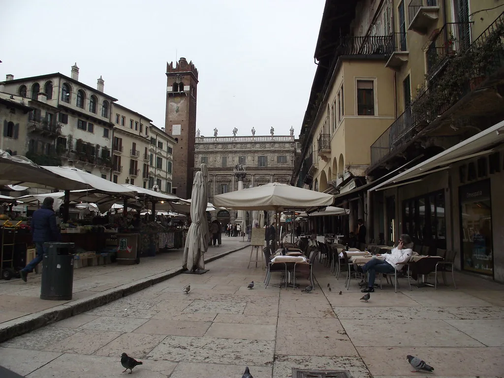Cobblestone street in Verona's historic centre lined with shuttered buildings