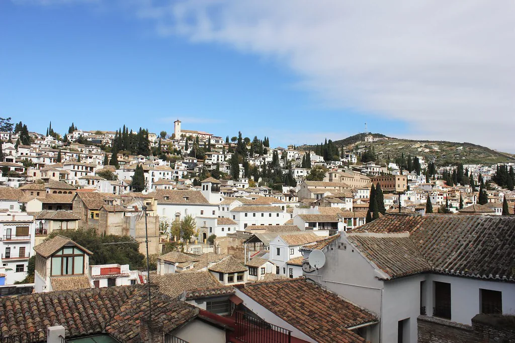 Snow-dusted Granada rooftops with the Sierra Nevada peaks behind on a clear winter day