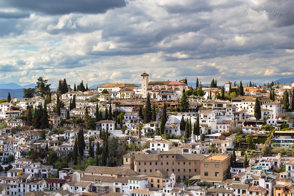 Sunlit cobbled street in Granada, Spain on a hot July day