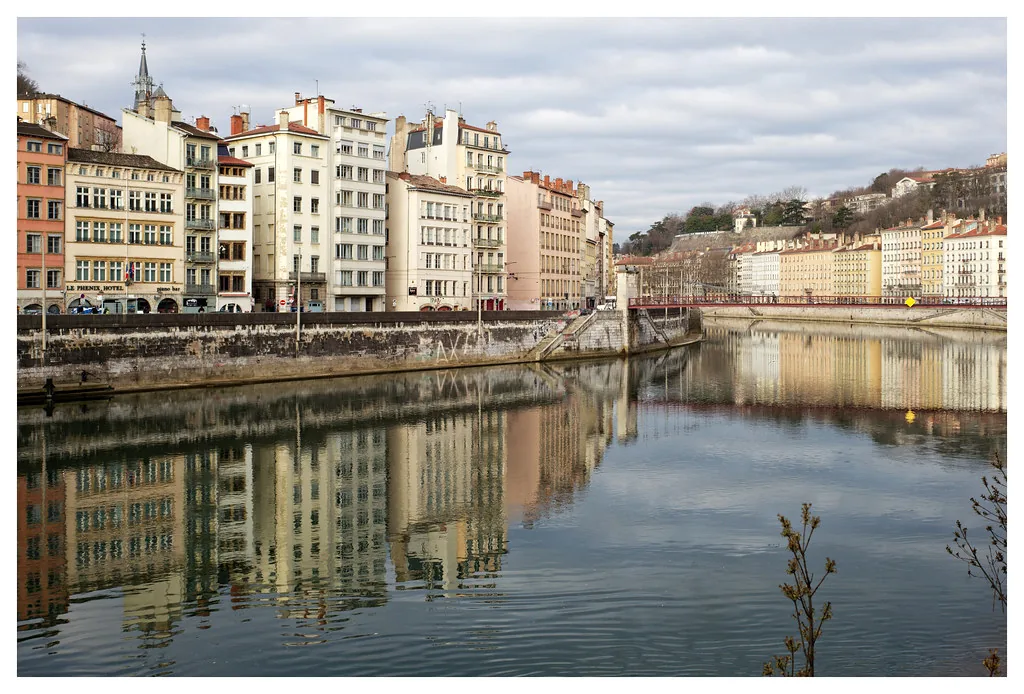 A Lyon street in winter showing how locals layer neutral-toned coats and scarves