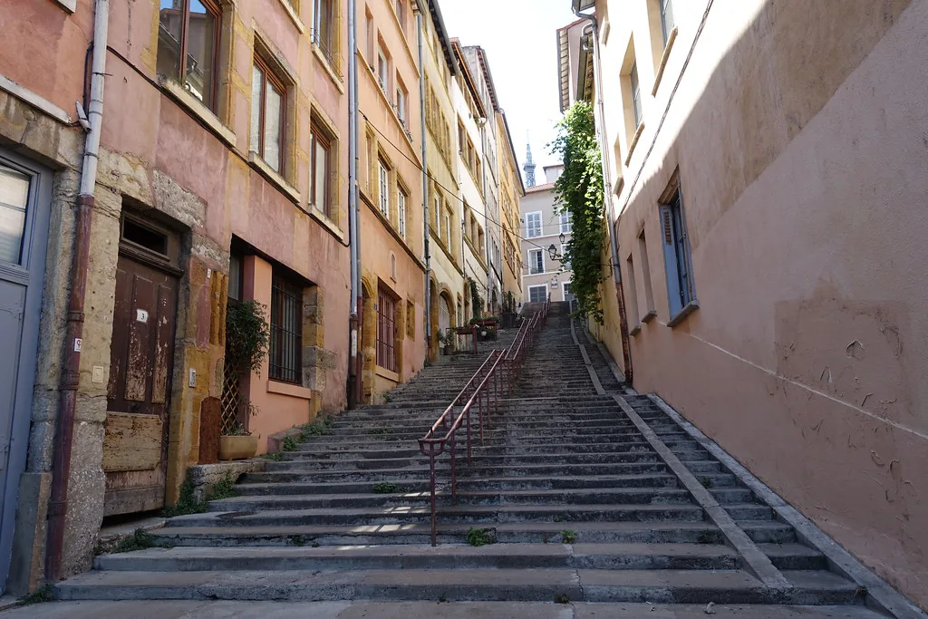 Springtime street scene in Lyon, France, illustrating the casual-elegant layering locals favor in March