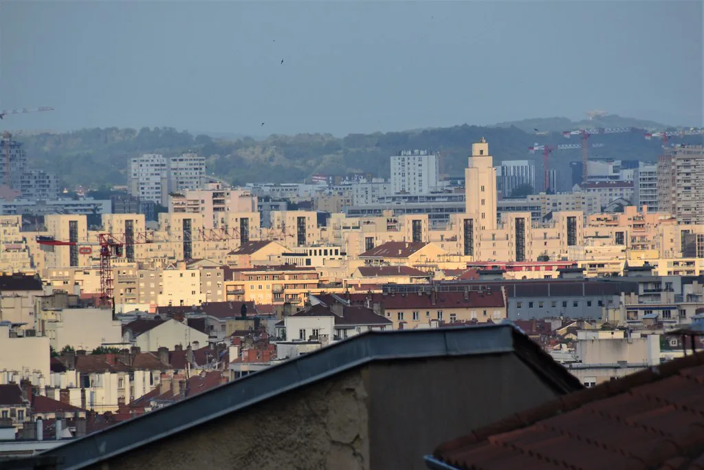 Wide view of Lyon, France, with the Saône riverfront and old town rooftops under early-spring skies