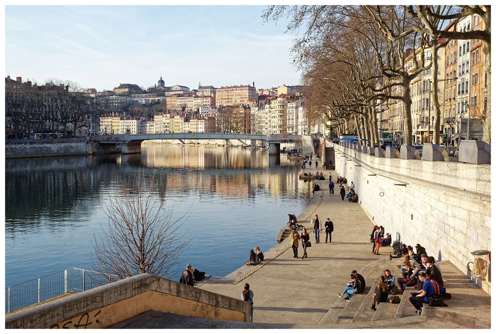 Autumn light over Lyon, France, showing the layered neutral wardrobe that suits October weather