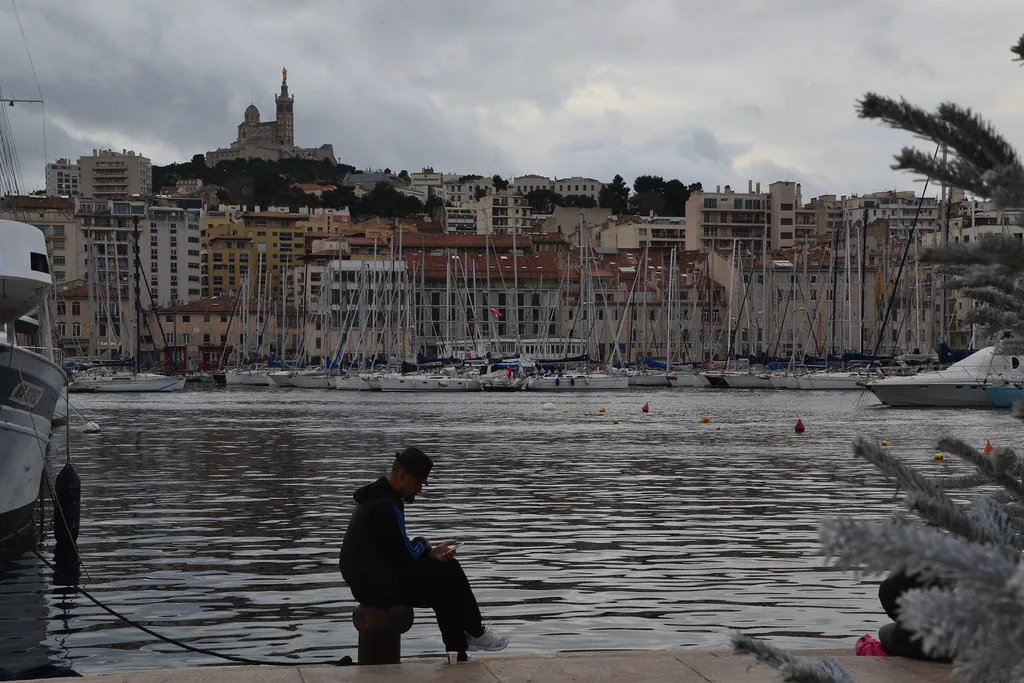 Marseille rooftops and harbour in spring light, with the hilly terrain locals walk in supportive footwear