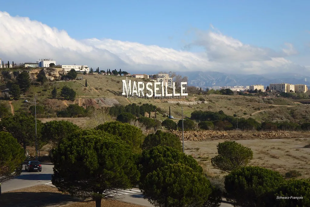 A street in Marseille, France in winter showing the kind of neutral-toned layered outfits that suit December weather