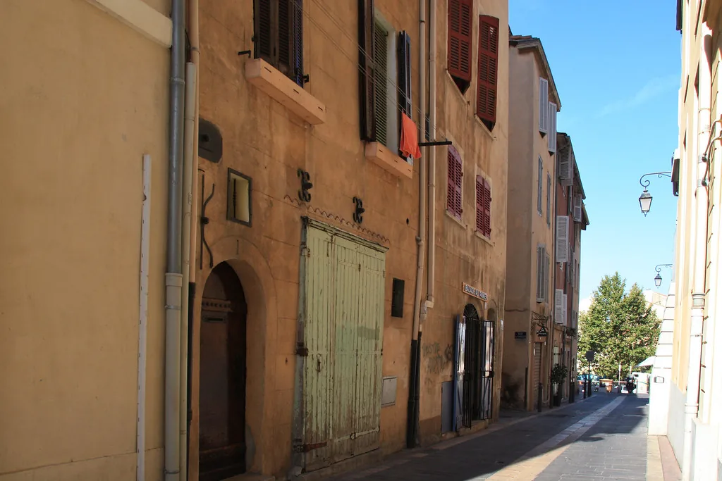 Marseille street scene in early summer with travelers in light June outfits