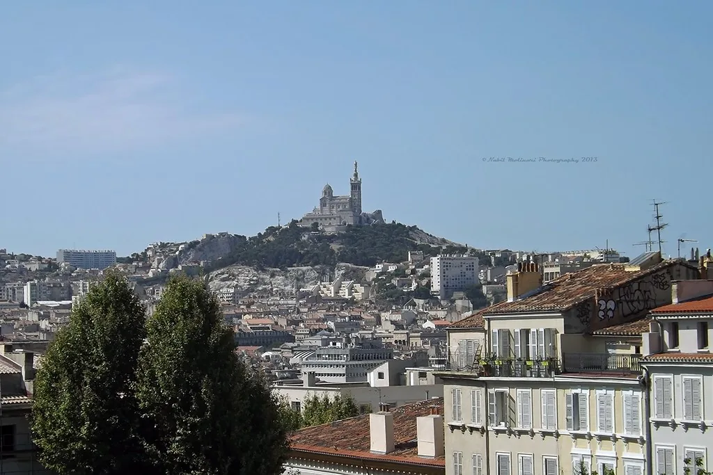 Marseille rooftops and harbour view under warm light, showing the mild September Mediterranean climate