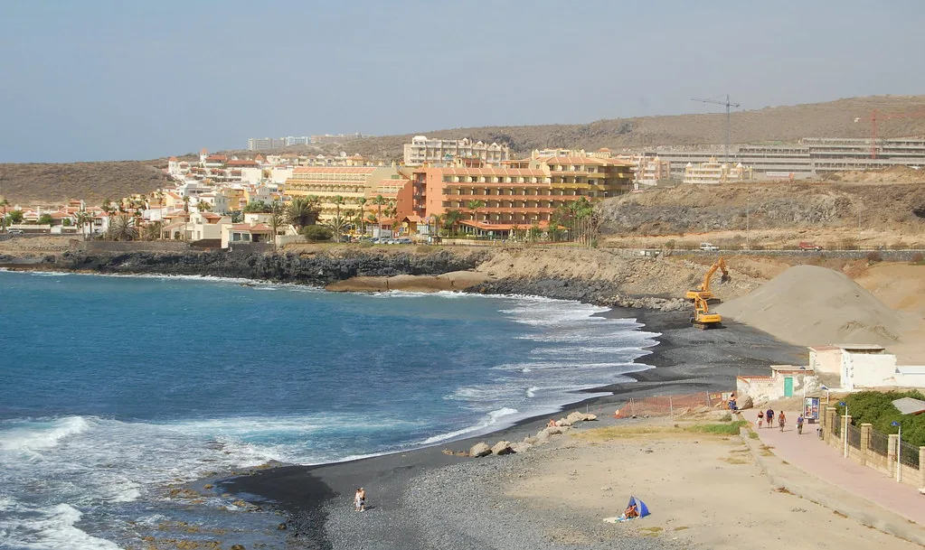 Sunlit Tenerife street scene in summer, showing the light warm-weather clothing typical for June