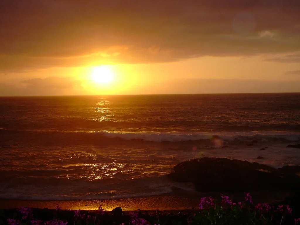 Tenerife coastline in spring sunshine near a lighthouse, where May sea breezes call for a light layer