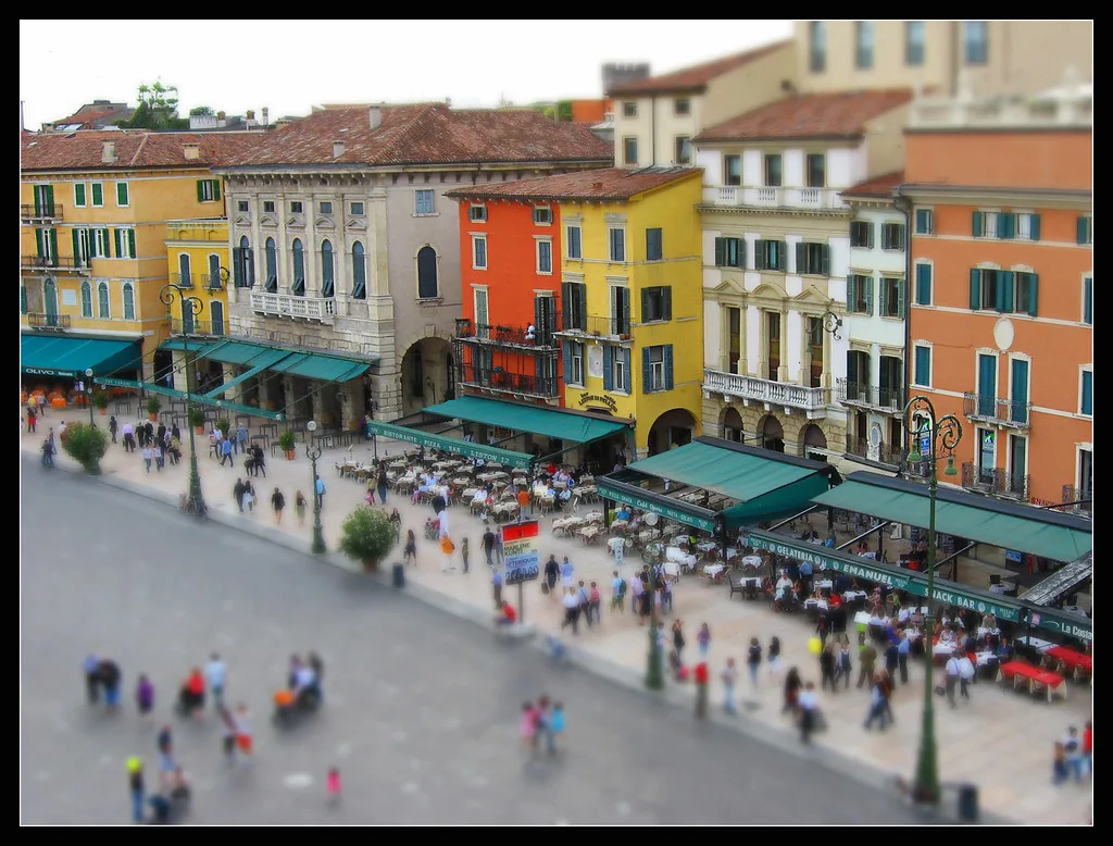 A sunlit cobbled street in central Verona, Italy in summer