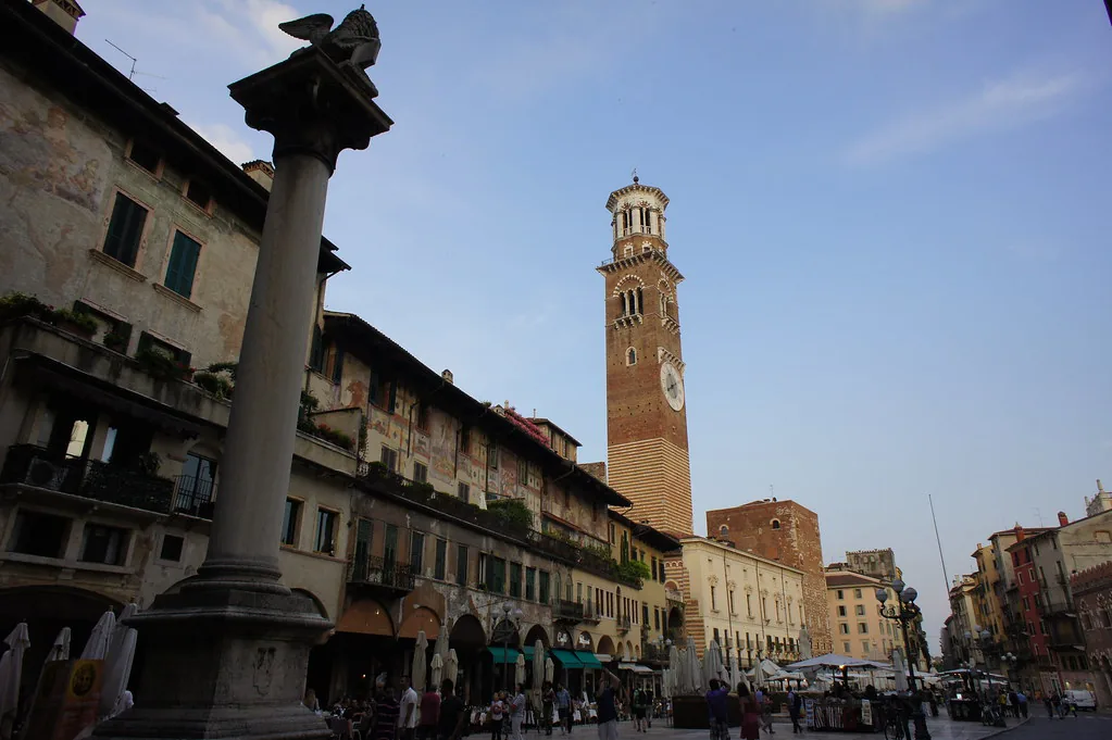 A sunlit historic street in central Verona, Italy on a hot July day