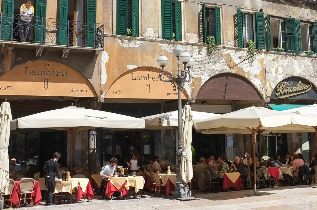 A street in Verona's historic center, Italy, lined with autumn-toned buildings